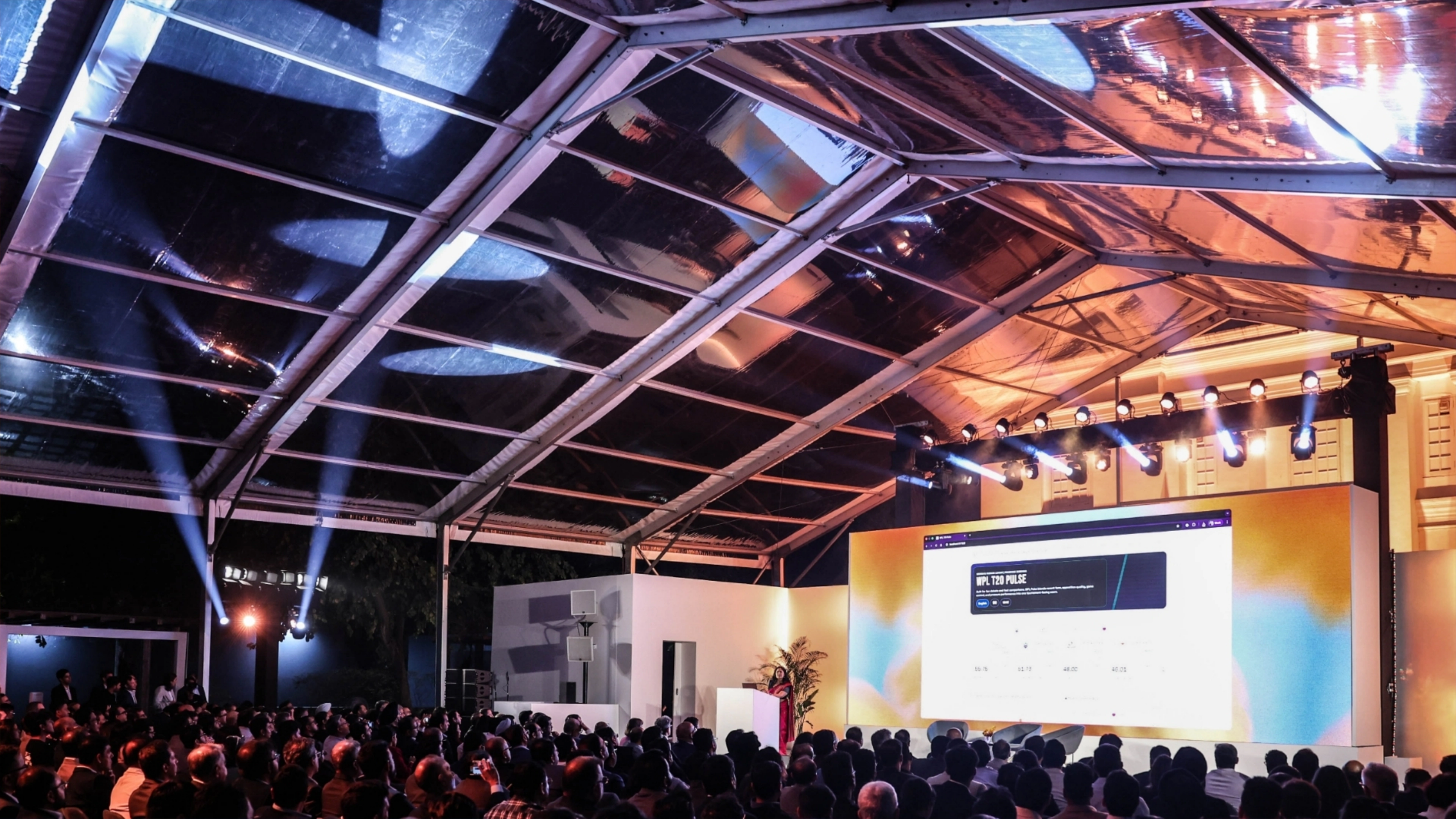 OpenAI India Tour - Closeup of traditional marigold decorations mixed with modern LED lighting installations