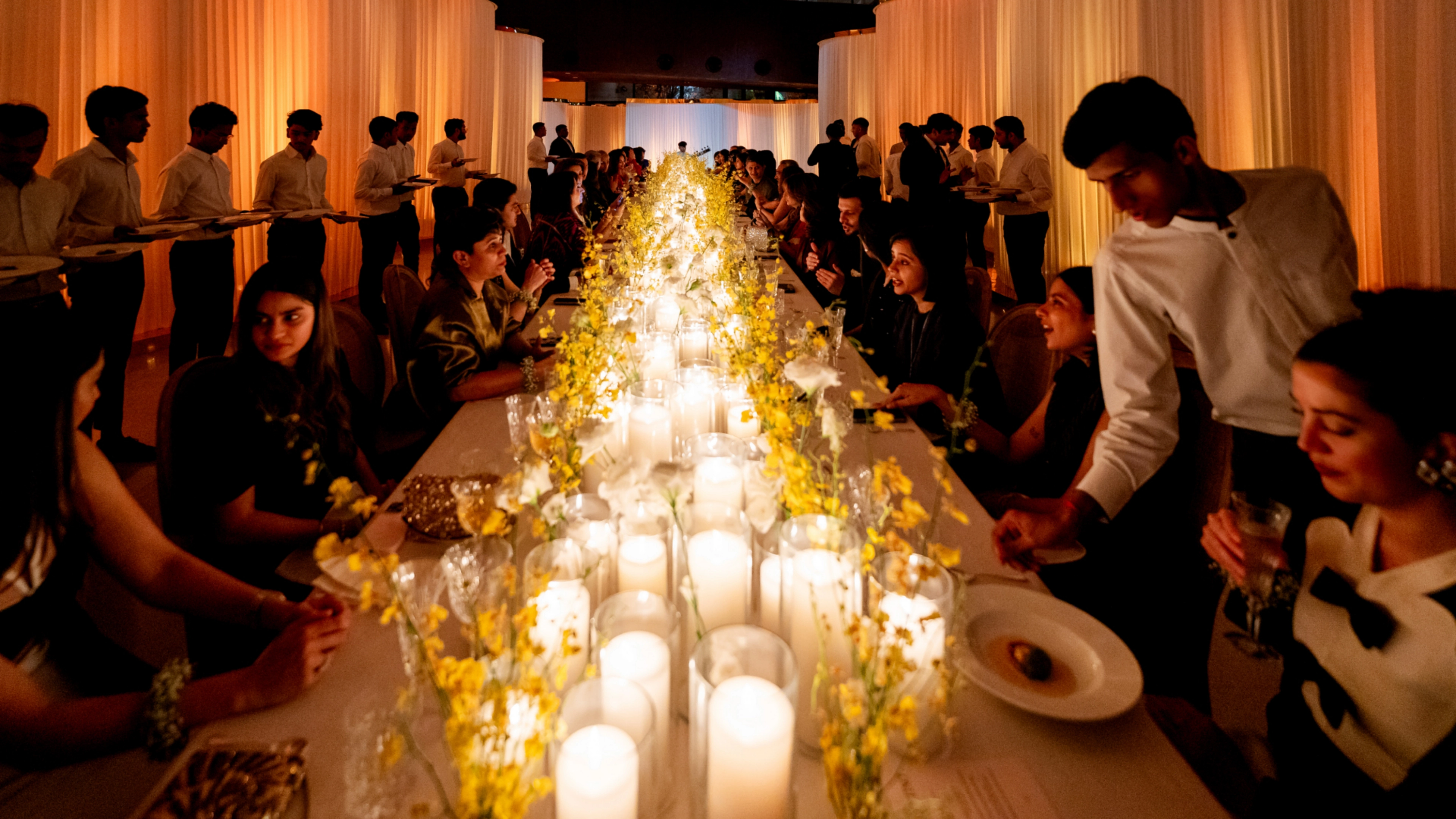 Valentino Diwali Dinner luxury fashion event - closeup of premium floral arrangements, candle details, and exquisite table settings